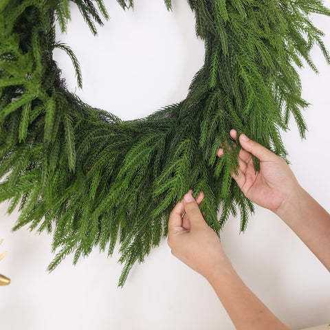 GLIDLION unboxed wreath being fluffed to restore shape quickly