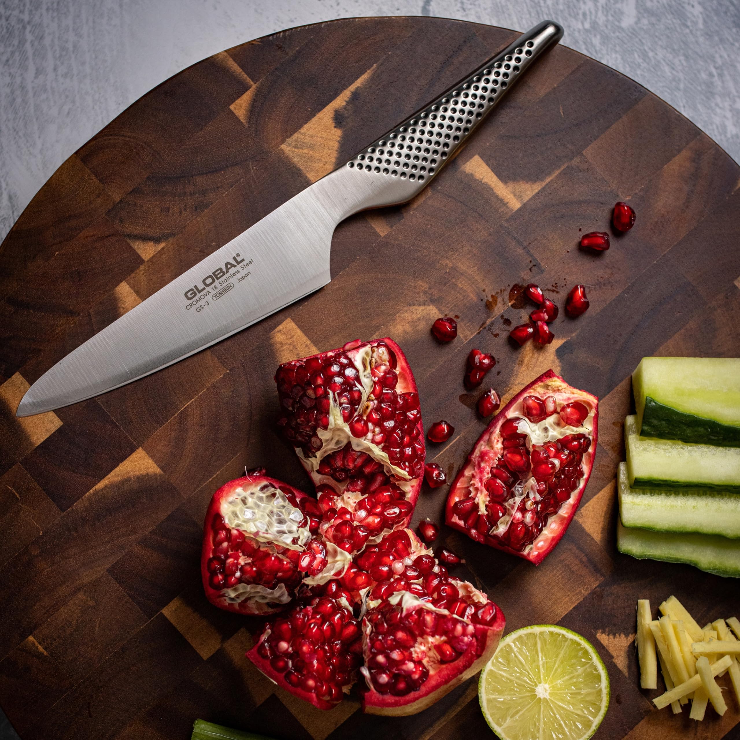 Global slicing cheese on a board to show thin, even cheese slices
