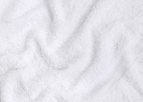 GOLD TEXTILES towels in laundry basket showing lightweight fast-drying benefit