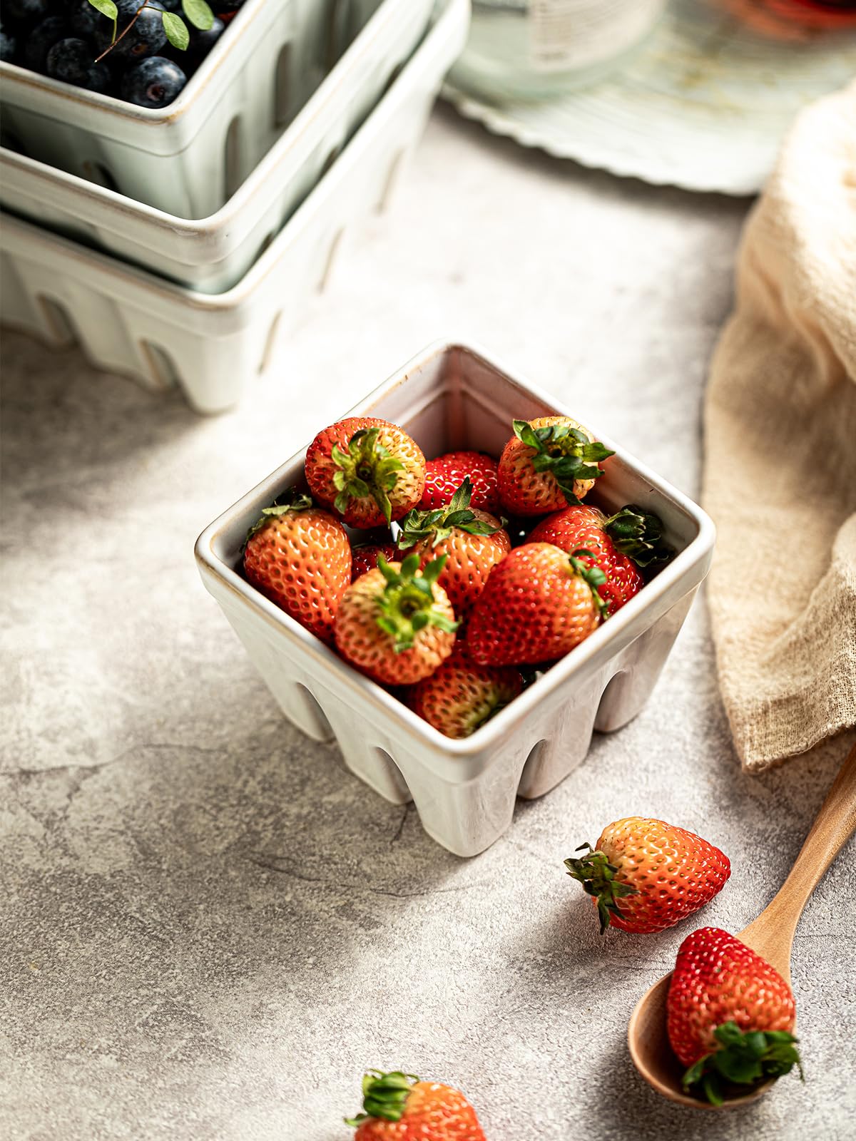 Gomakren berry basket beside a hand for scale showing compact helpful size