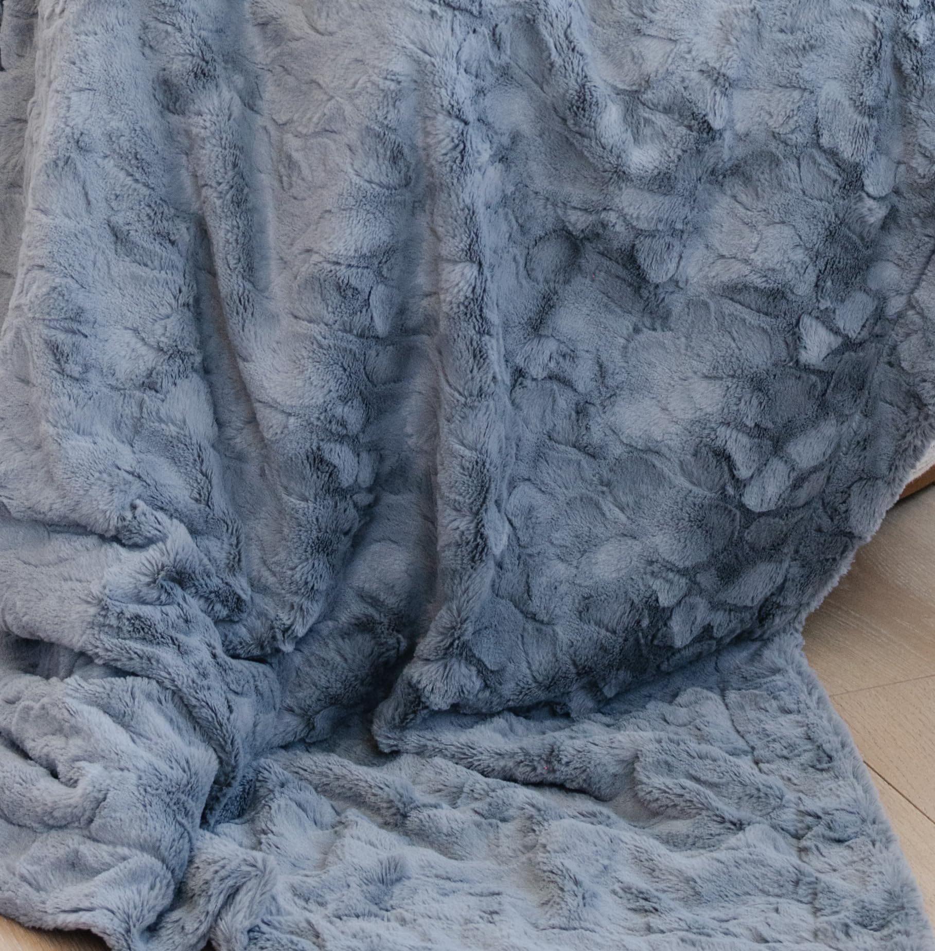 GRACED SOFT LUXURIES blanket draped on sofa illustrating stylish décor and warm comfort