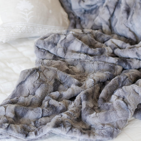 GRACED SOFT LUXURIES draped over sofa showing decorative warmth