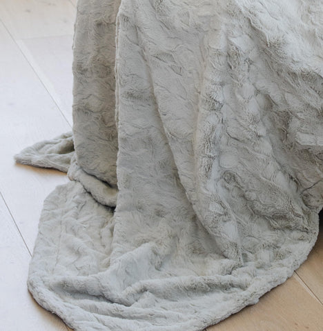 graced soft luxuries folded on bed illustrating generous size and neat layering
