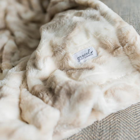 GRACED SOFT LUXURIES throw styled on sofa enhancing living room comfort and decor