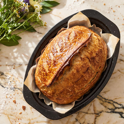 Granite bowl roaster inside oven demonstrating even heat distribution for reliable roasting
