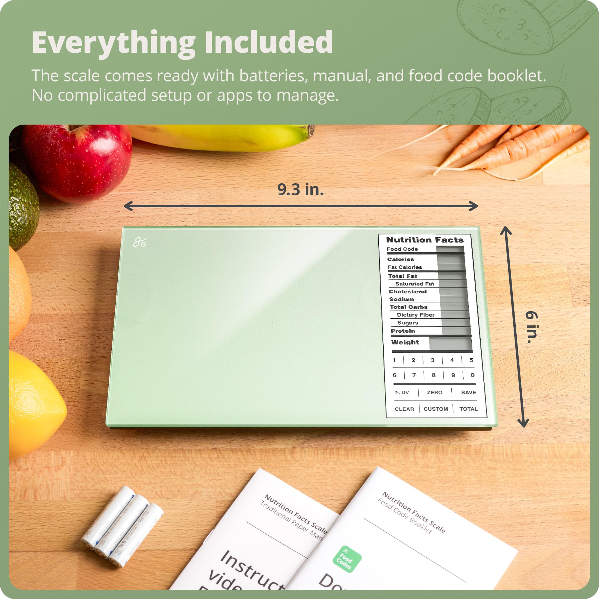 Greater Goods scale beside spoon and apple to show compact size and portion control benefit