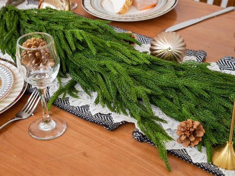 Green Moon garland styled on a mantel demonstrating festive layering and warmth