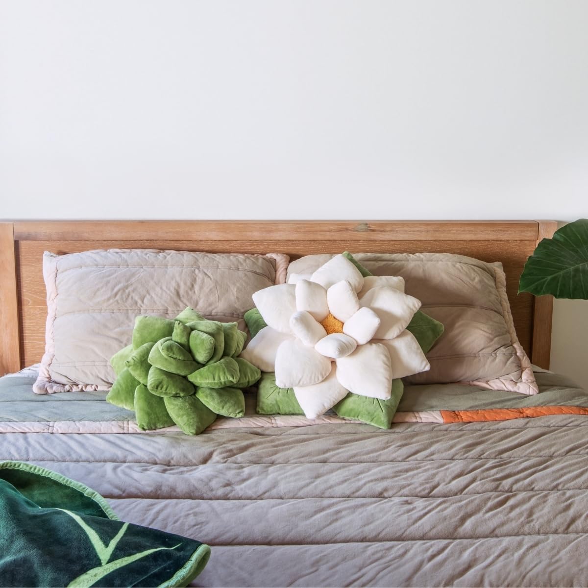 Green Philosophy Co. pillow next to hand shows 16-inch compact scale