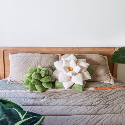 Green Philosophy Co. pillow next to hand shows 16-inch compact scale