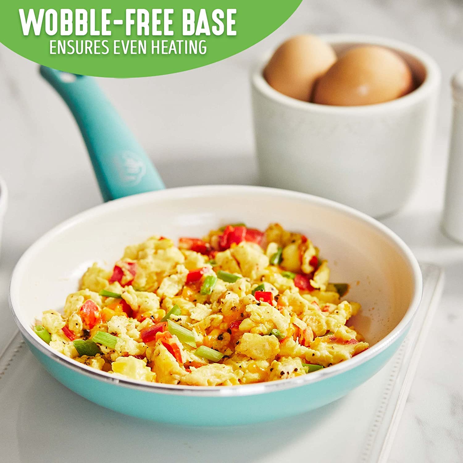 GreenLife pan cooking eggs on stovetop showing quick-release cooking benefit