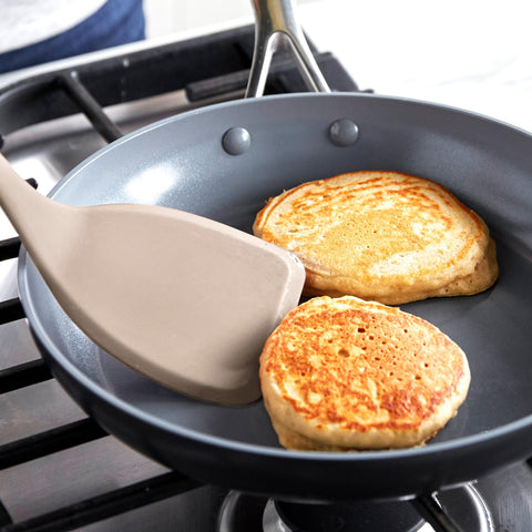 GreenPan turner beside utensil holder illustrating compact storage convenience benefit