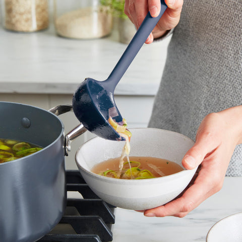 GreenPan flexible tool edges bending into pan corner, demonstrating reach and cleaning benefit