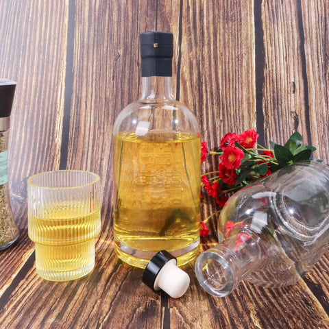 GUANENA bottle held in hand to show 750ml size and real-world scale