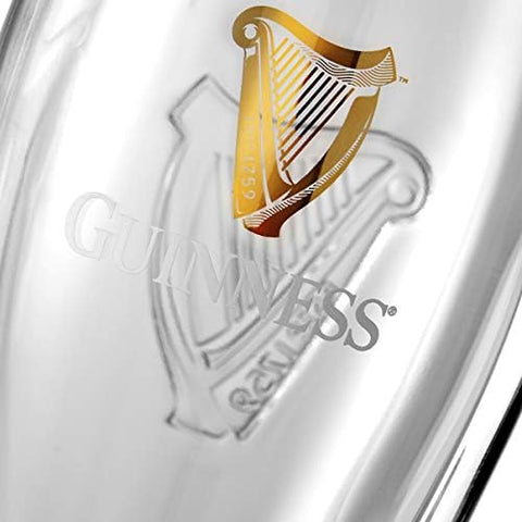Guinness glass filled with stout sideview showcasing rich color and head