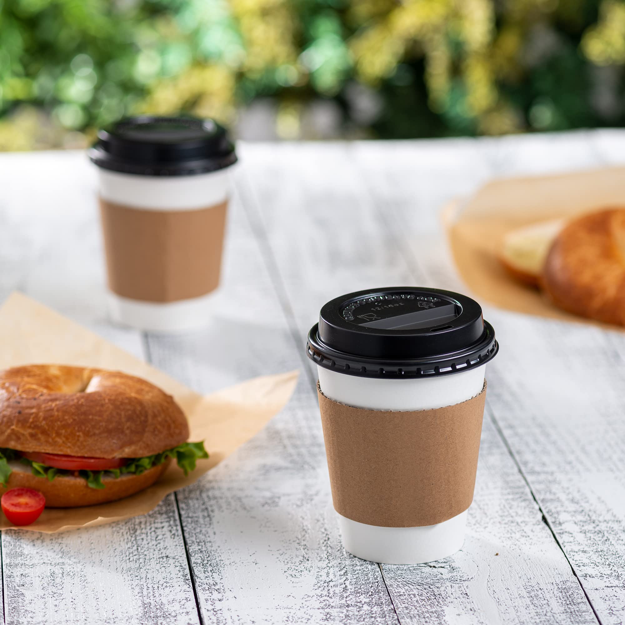 GUSTO cup beside phone to show 12 oz size and portable serving