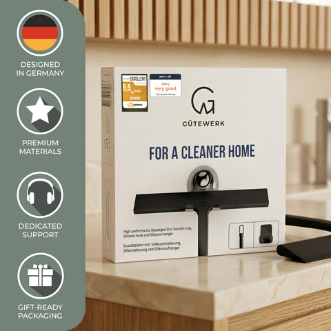 GÜTEWERK squeegee clearing shower glass in use for fast water and soap removal