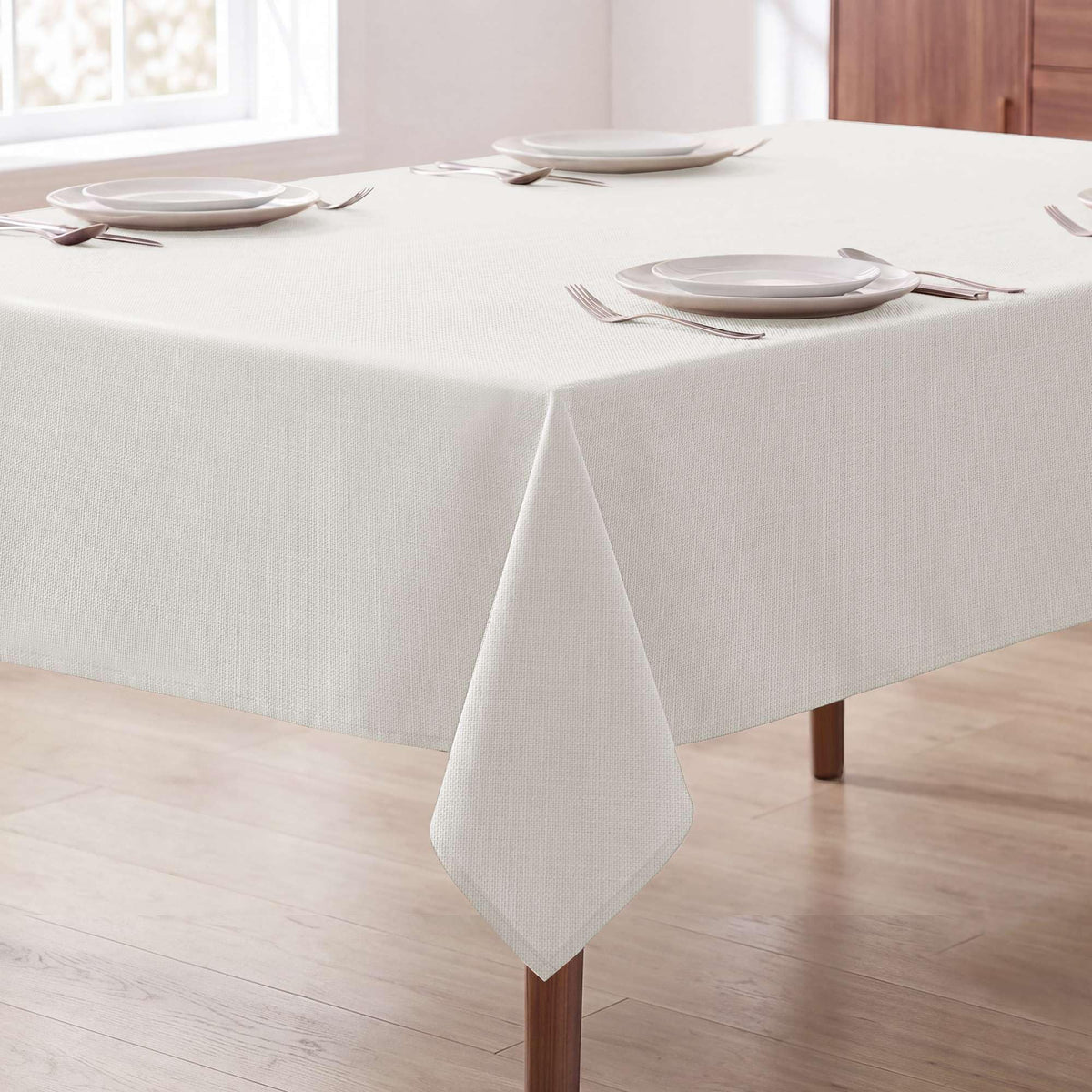 H.VERSAILTEX front view of ivory rectangular tablecloth shows clean modern look and protection