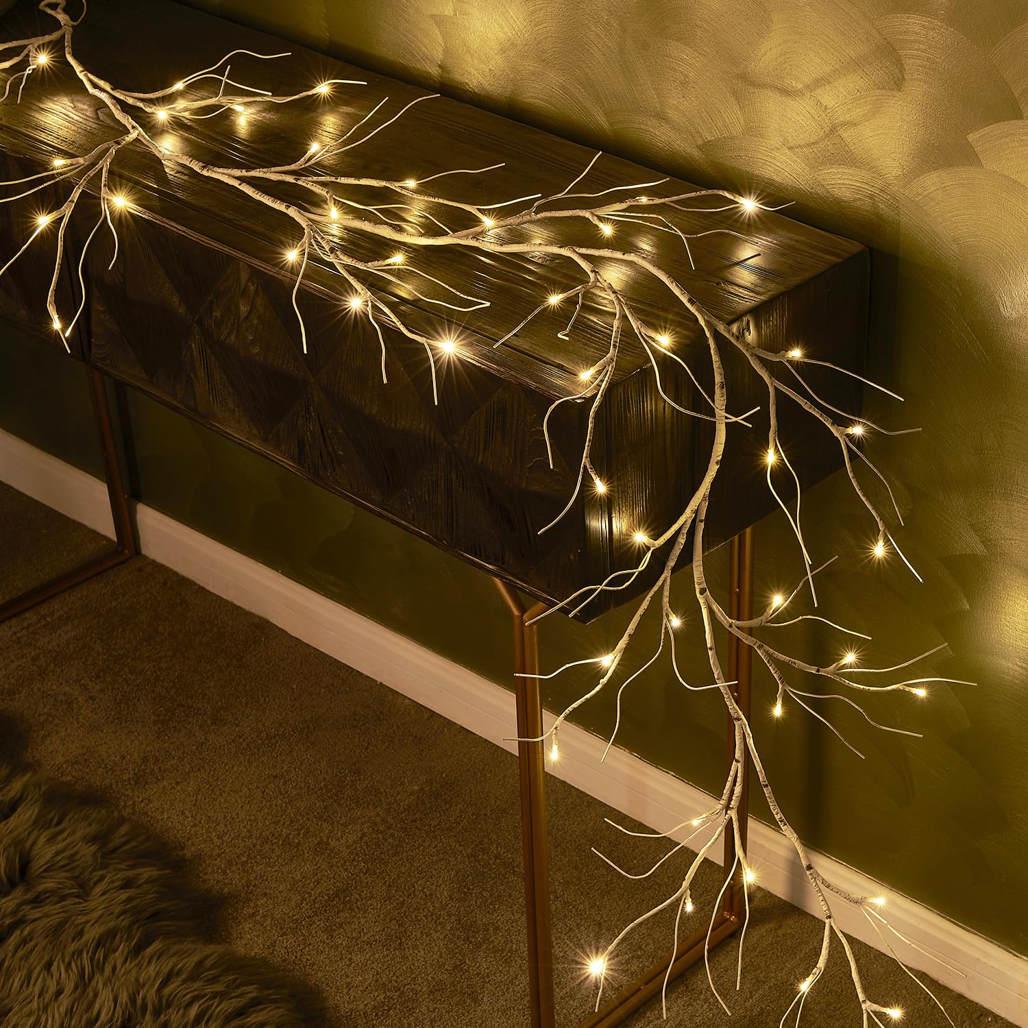 Hairui garland draped on mantel creating cozy fireplace holiday styling
