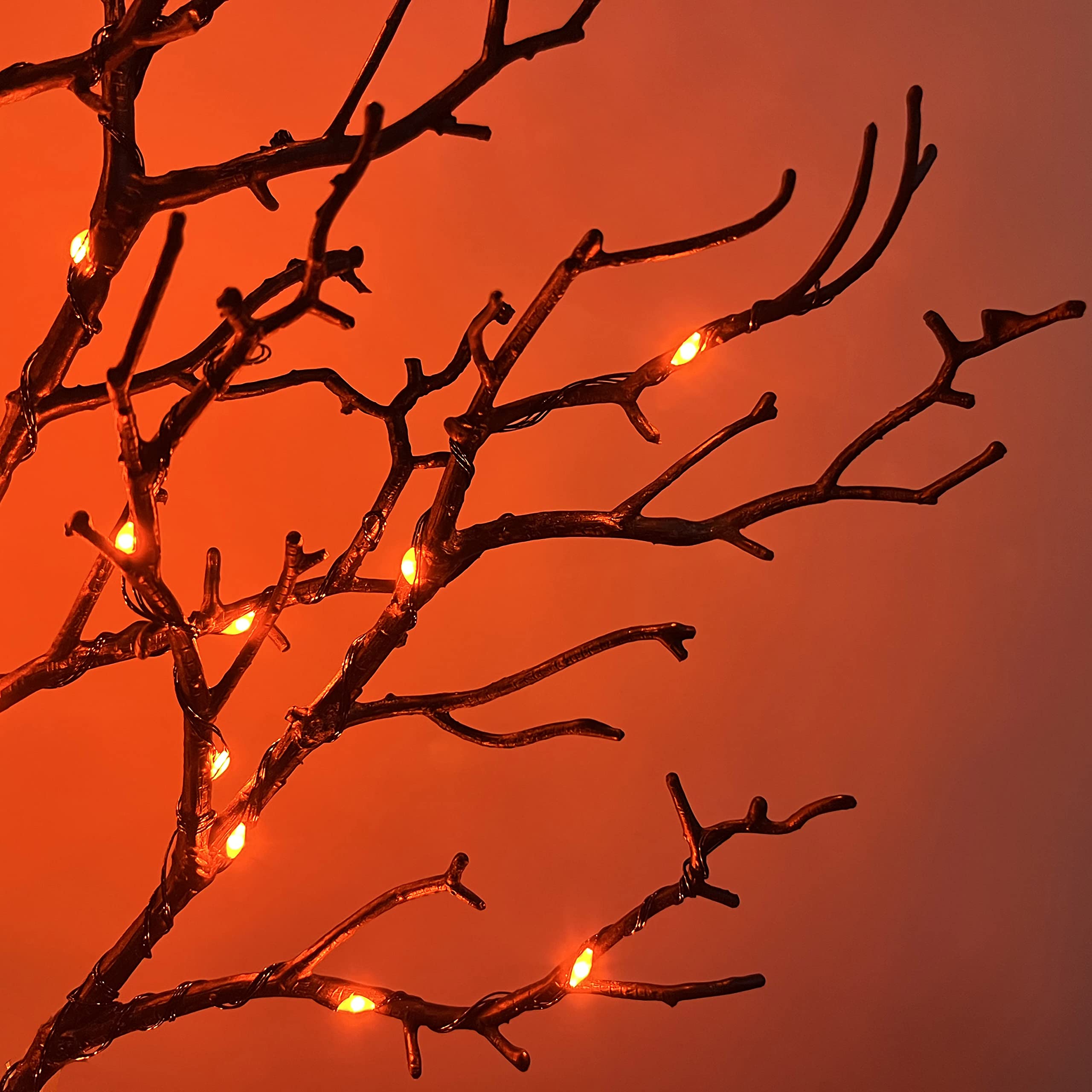 Hairui close-up of orange and purple LEDs on twig garland, clear color contrast benefit