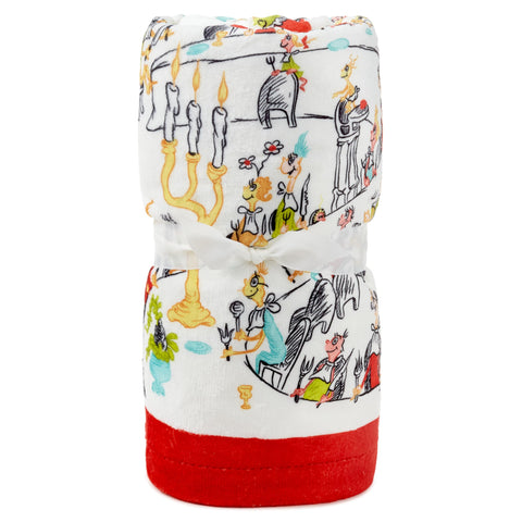 Hallmark Grinch throw draped on sofa illustrating cozy holiday atmosphere