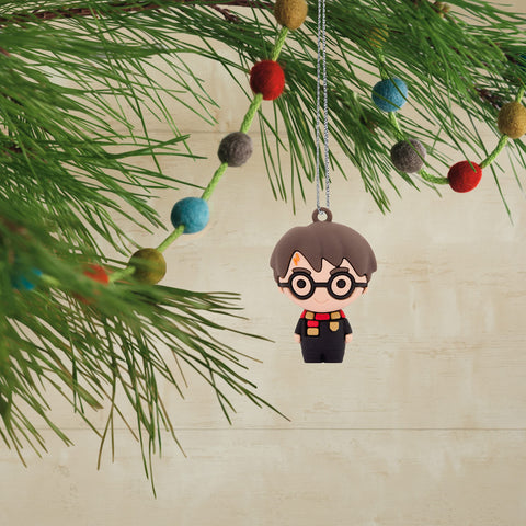 Hallmark child hanging an ornament on tree illustrating safe, kid-friendly fun