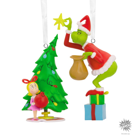 Hallmark ornaments held in hand showing scale and gift-ready size