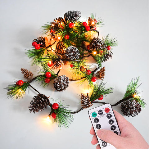 HamiFinee garland front view showing pine needles, cones, berries and warm lights for instant ambiance