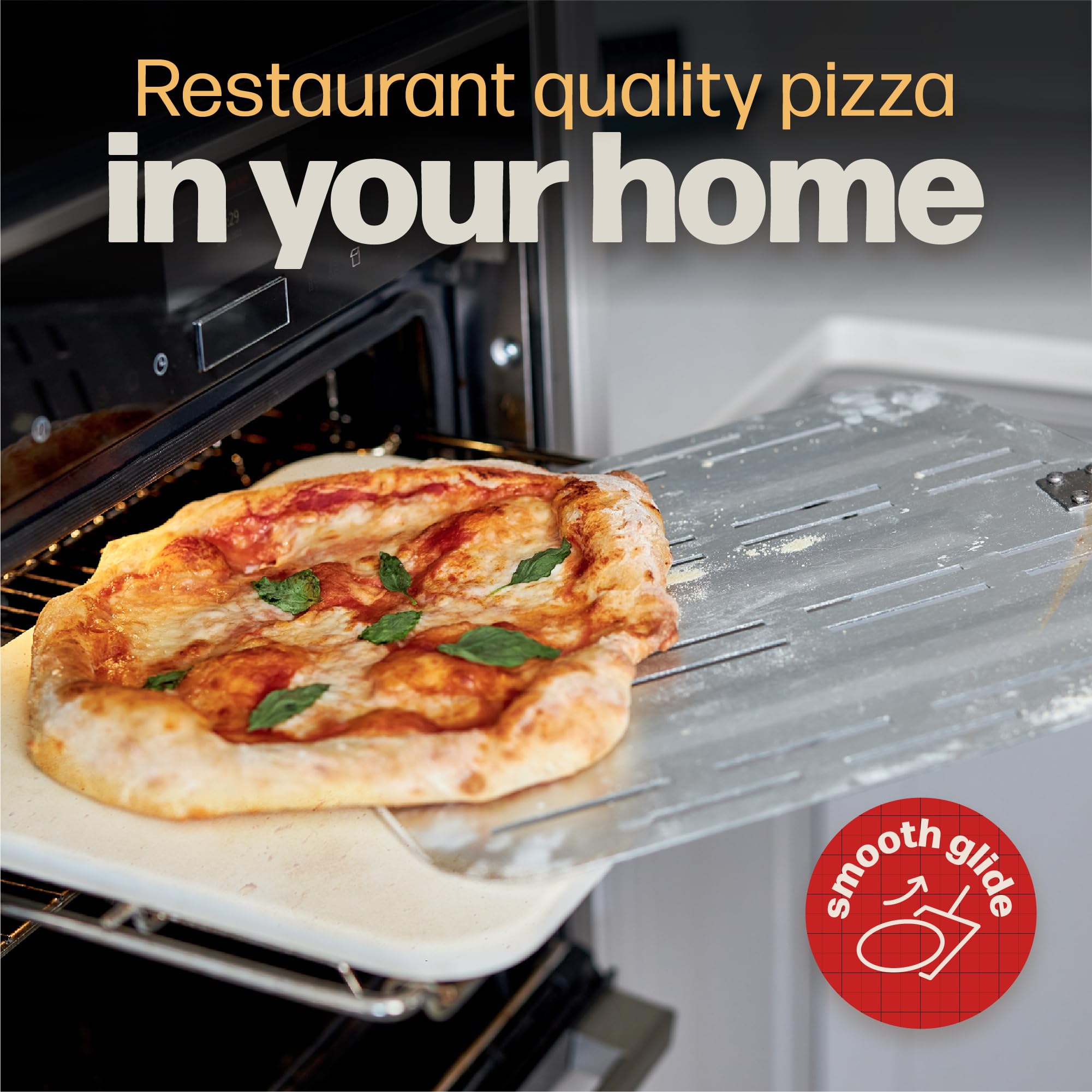 Hans Grill peel being used to place pizza in a hot oven for easy safe transfers