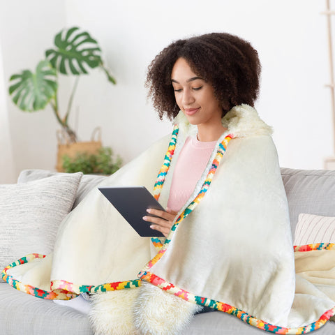 Happy Fuel model wearing hooded blanket holding mug for hands-free warmth
