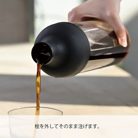 HARIO pouring cold brew from bottle demonstrating controlled pour and spill reduction