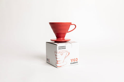 HARIO V60 pouring over mug demonstrating precise pour control and single-hole flow