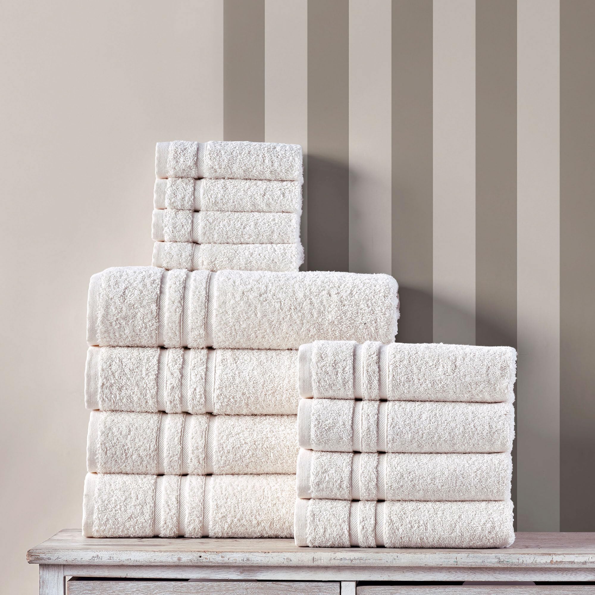 Hawmam Linen folded towel stack on shelf showing tidy storage and coordinated spa-like aesthetic