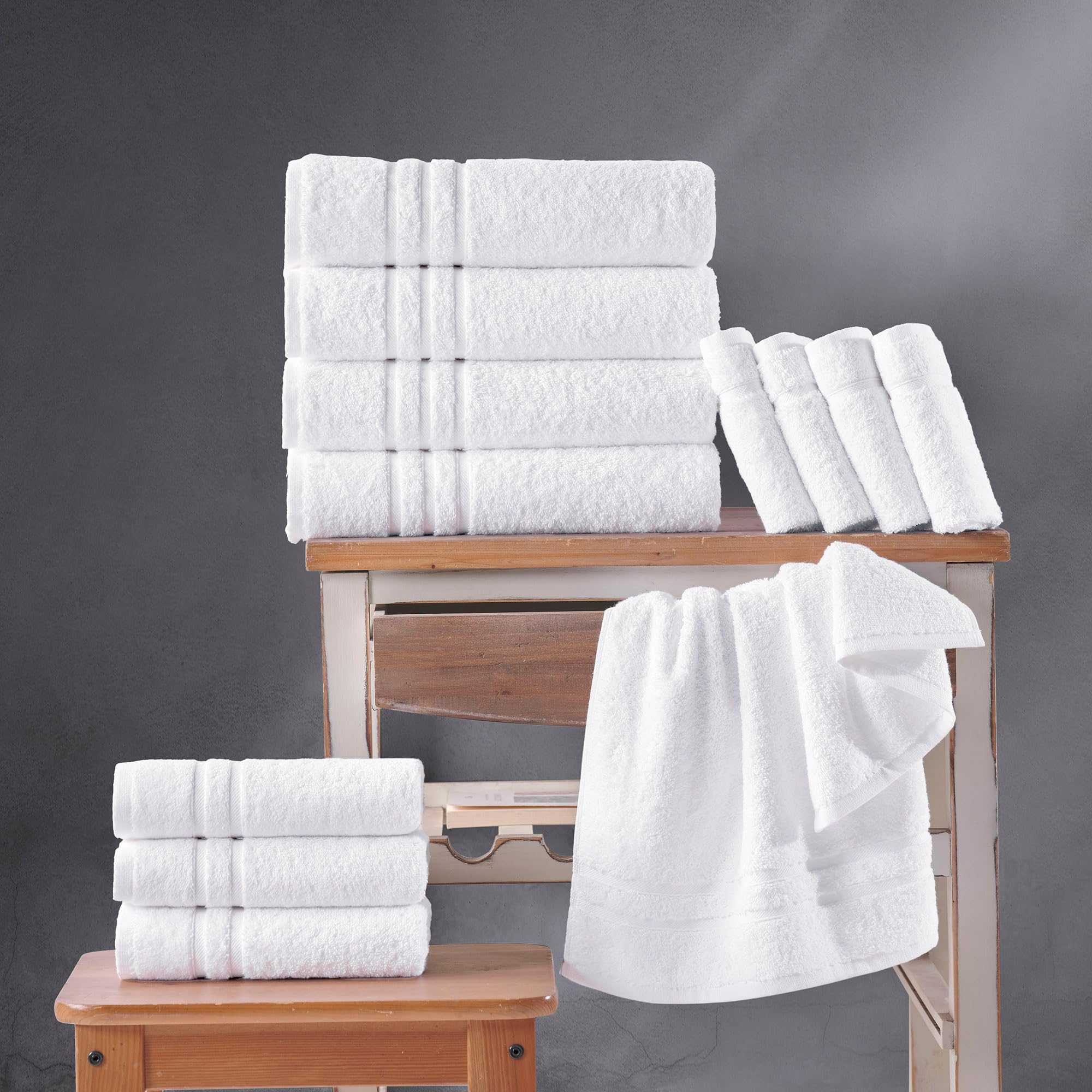 Hawmam Linen towel next to hand for scale showing generous 27x54 size