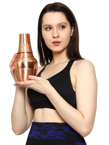 HealthGoodsIn carafe pouring water into tumbler showing spill-safe pour benefit