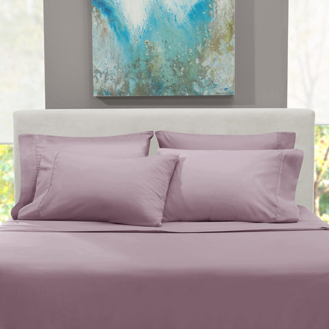 Hearth & Harbor styled bedroom with dusty purple sheets creating calm ambiance