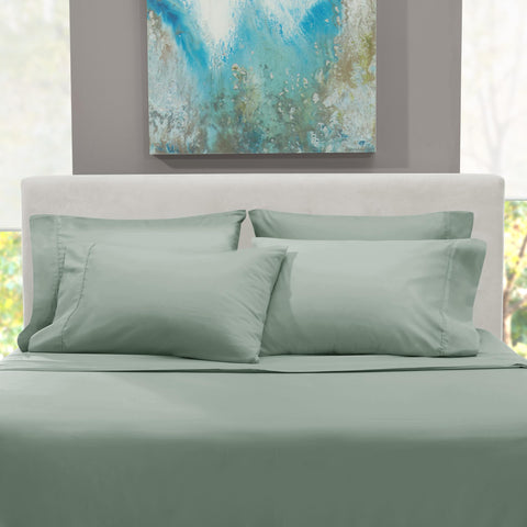 Hearth & Harbor styled bedroom with sage sheets, conveys cozy hotel-like atmosphere