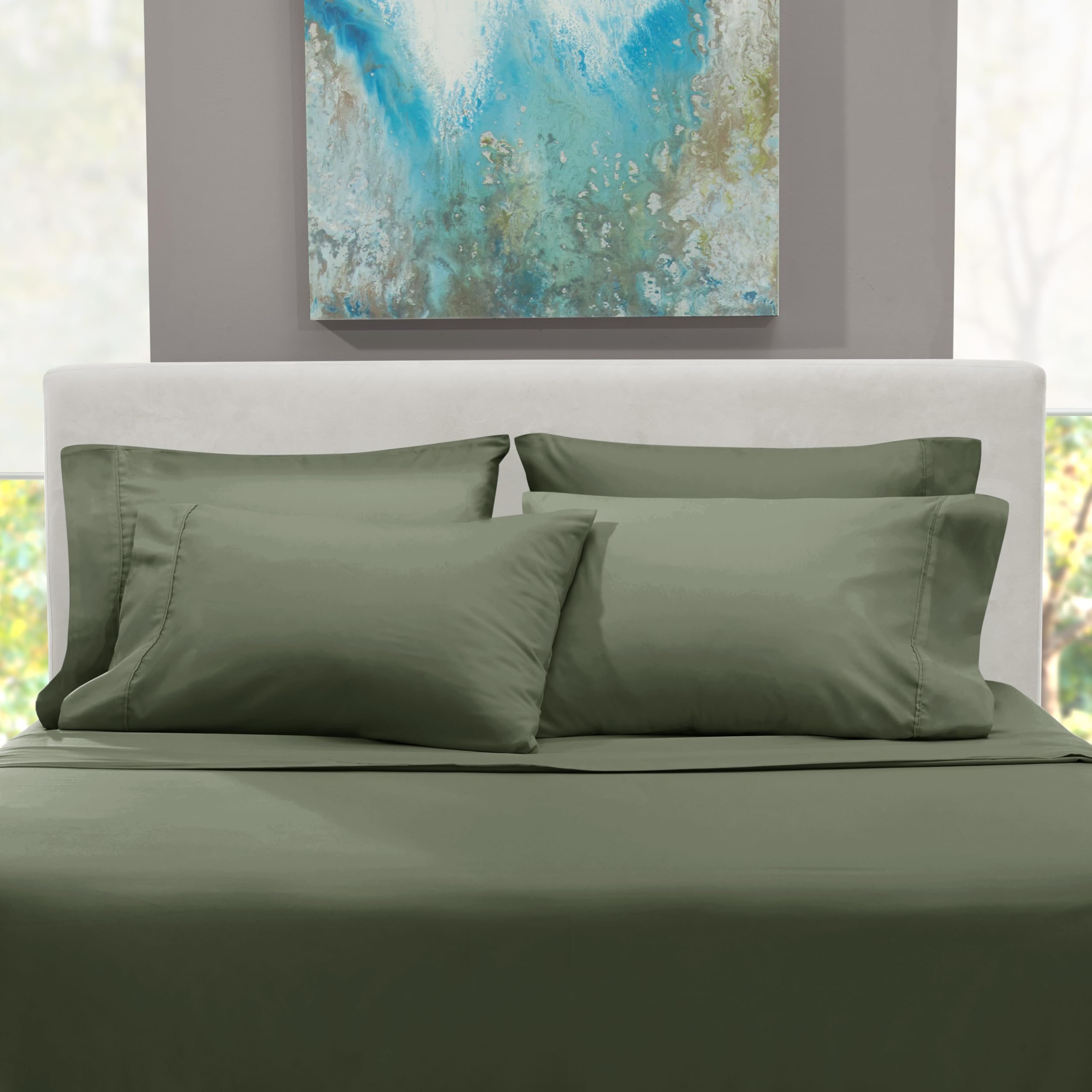 Hearth & Harbor styled bedroom with olive sheets highlighting color and cozy appeal