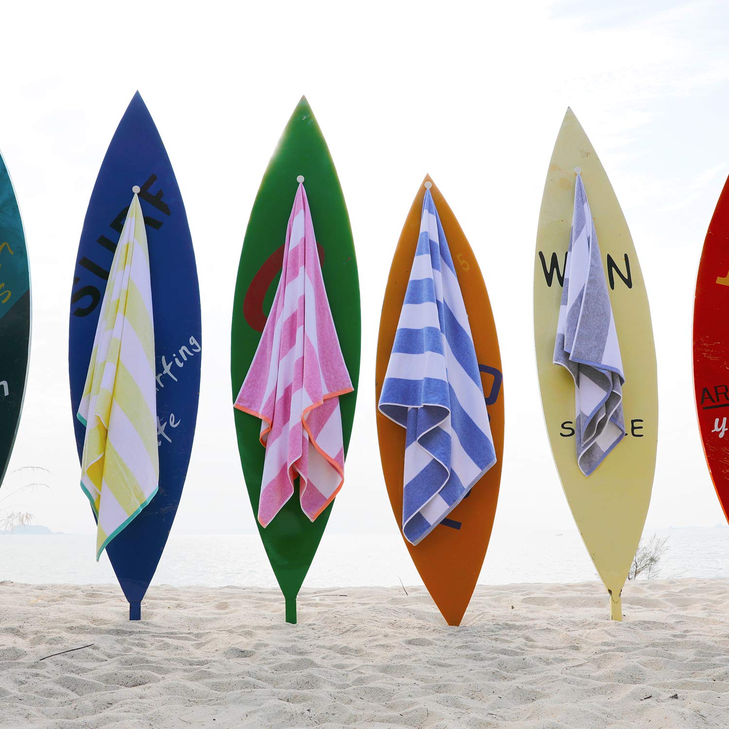 HENBAY towel with person lying on it showing generous 70x35 inch coverage benefit