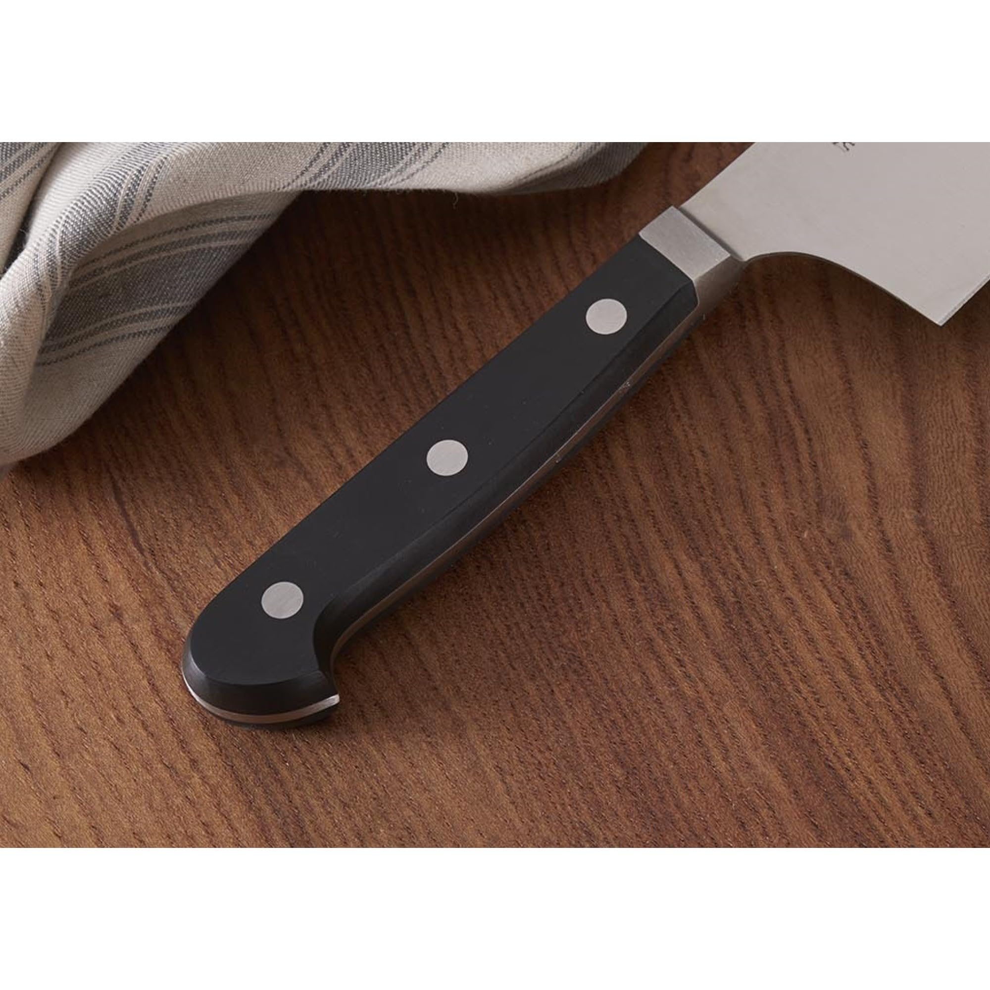 HENCKELS knife in use chopping vegetables for fast, efficient meal prep