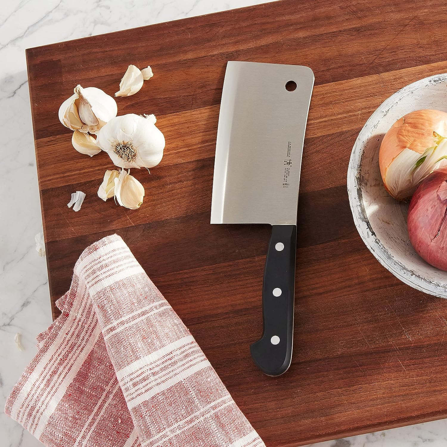 HENCKELS cleaver handle close-up highlighting triple-rivet grip for secure control