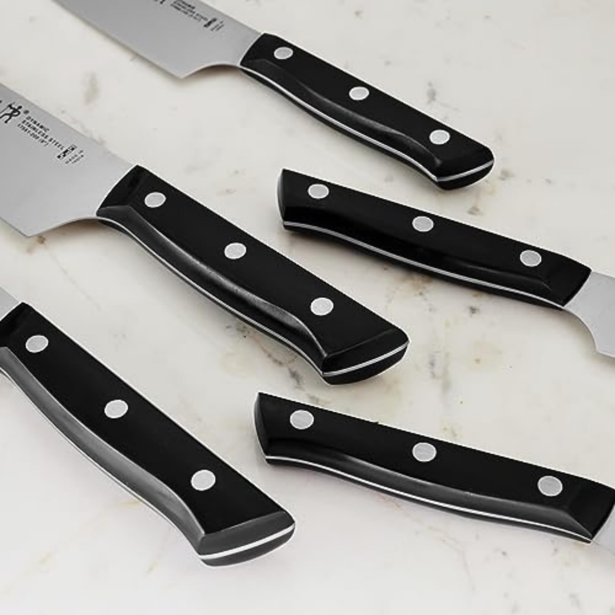 HENCKELS chef’s knife in use chopping vegetables demonstrating effortless cutting