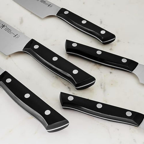HENCKELS chef’s knife in use chopping vegetables demonstrating effortless cutting