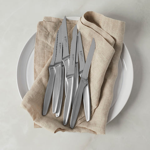 HENCKELS steak knife slicing cooked steak to show effortless cutting performance