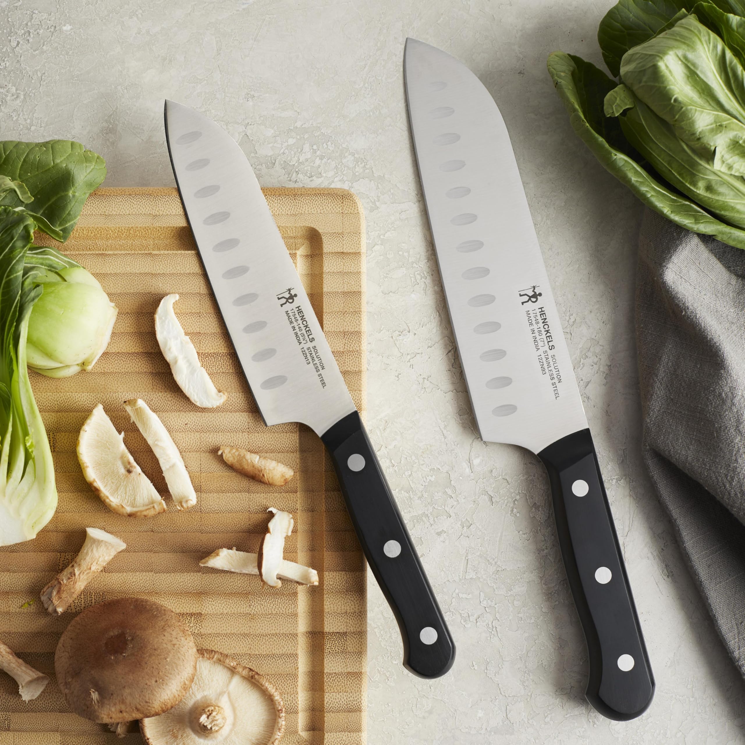 HENCKELS two-piece santoku set arranged to show included sizes
