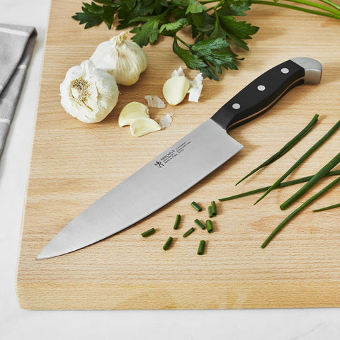 HENCKELS 8-inch chef knife blade closeup showing sharpness and control