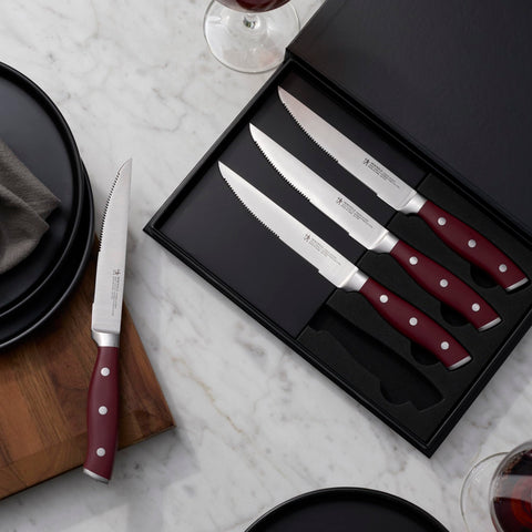 HENCKELS red-handled knives arranged on a dining table for stylish serving