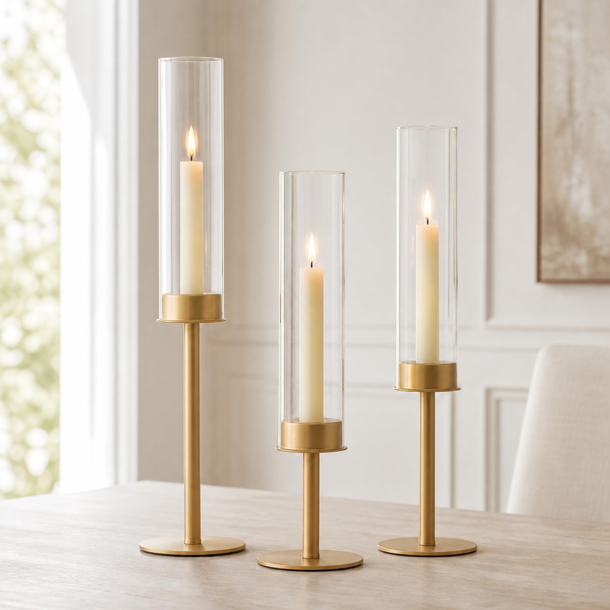 Hewory front view of three gold candlesticks showing elegant silhouette and balance