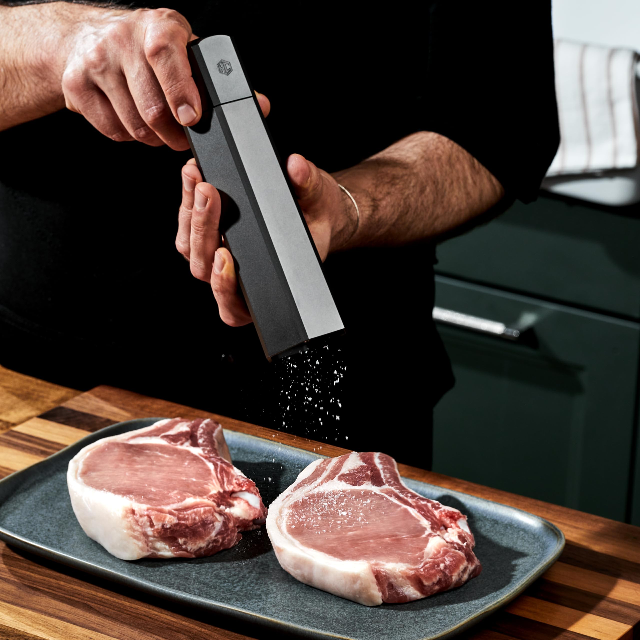 HexClad HexMill on kitchen counter seasoning steak to illustrate fast, precise seasoning