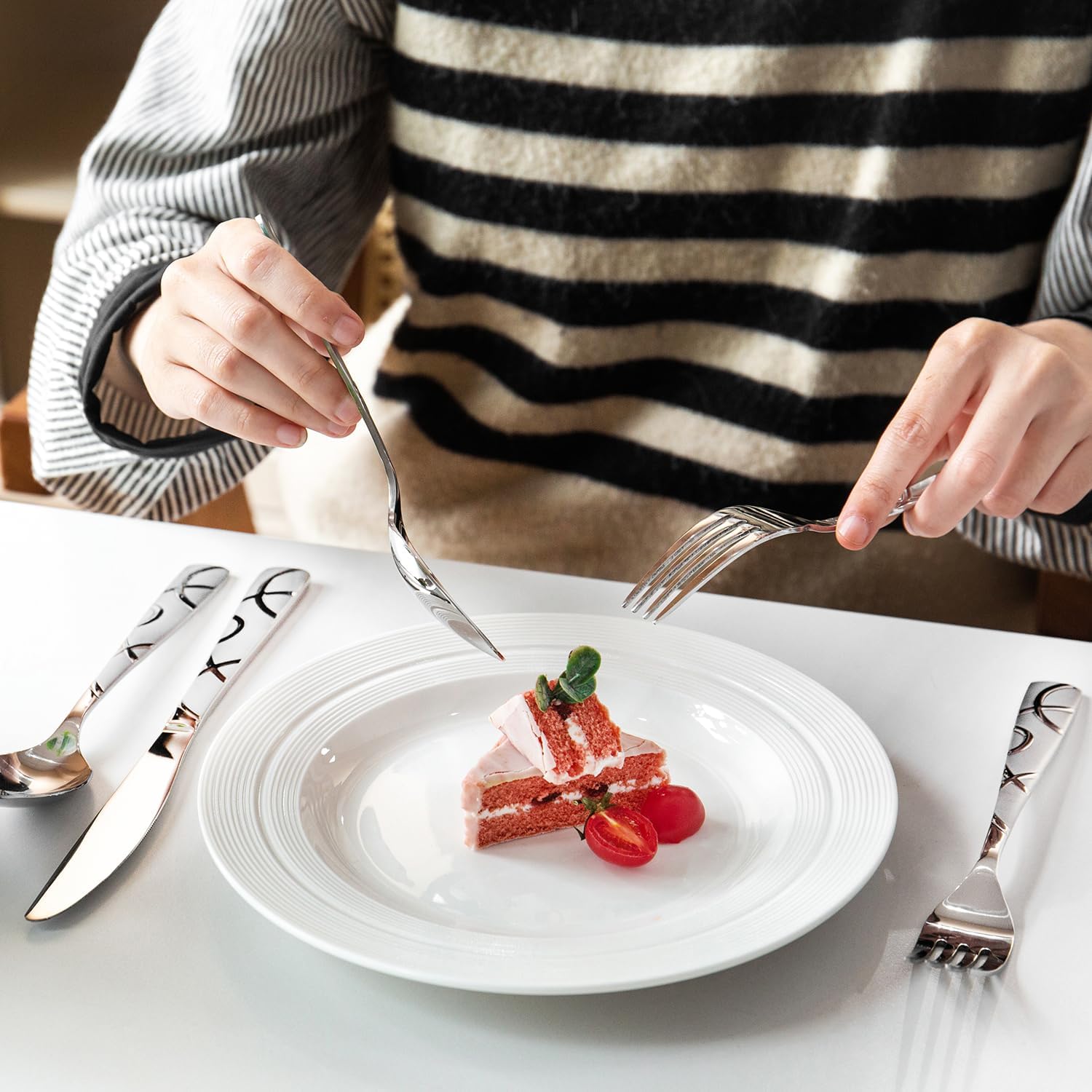 HIKAA cutlery next to a hand showing scale and comfortable ergonomics