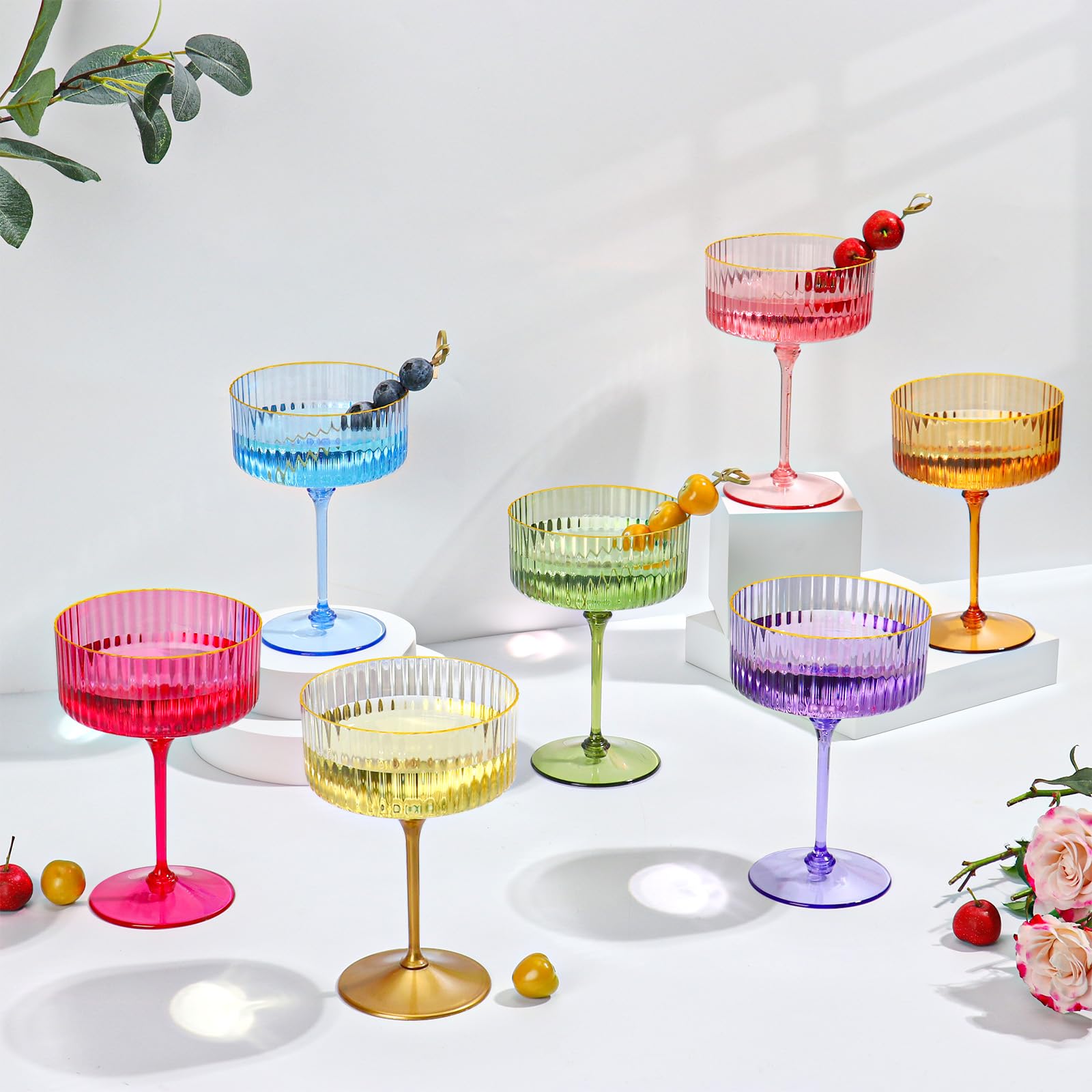 HKSZEH coupe glass in hand with cocktail showing party-ready presentation